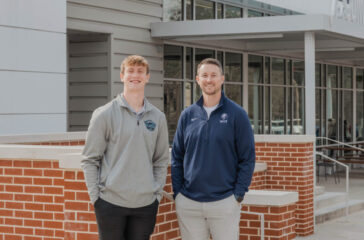 Ryan Moore, NCCS teacher and director of the Academy of Business, and Finley Ross, current UGA student and NCCS class of 2023 graduate PHOTO: LARUCHE PHOTO