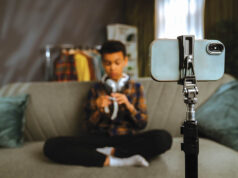 Using Social Media This Summer? Young Person Recording a Video at Home with Smartphone
