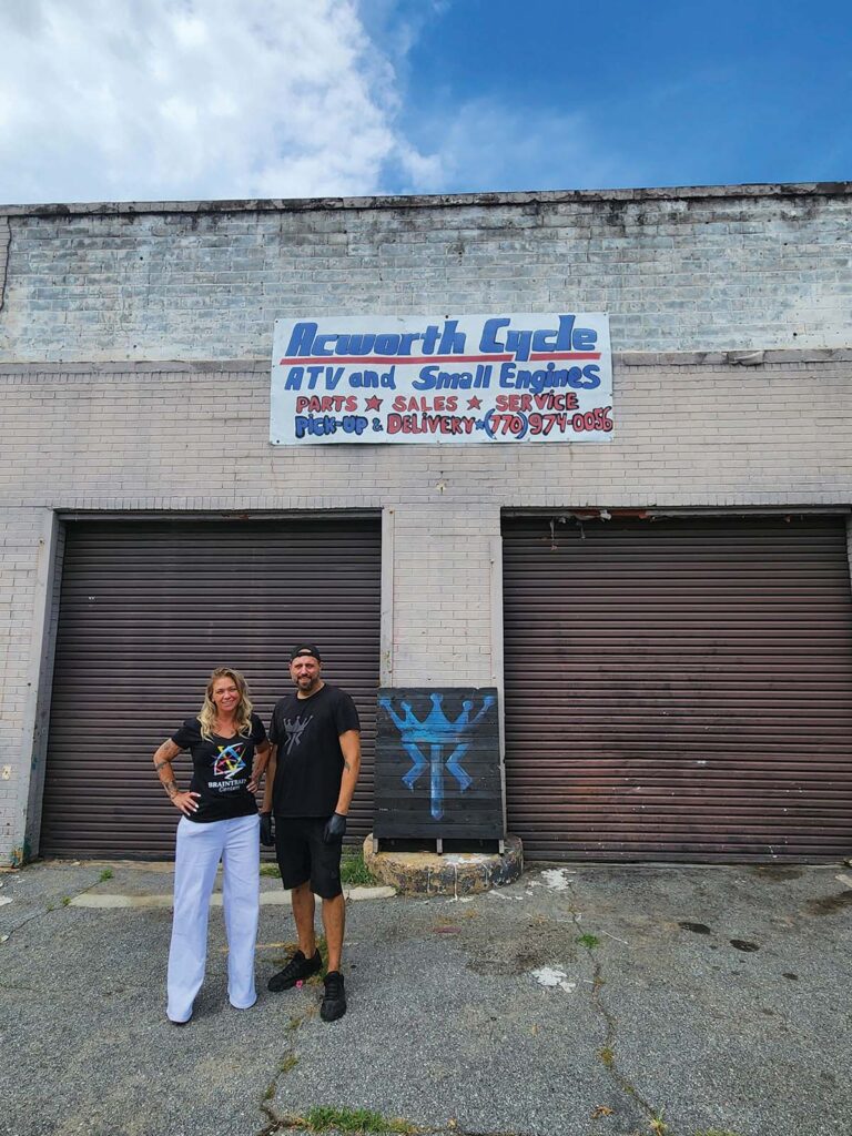Melissa Hegert and CJ Fidurski in front of the building as it looks today.
